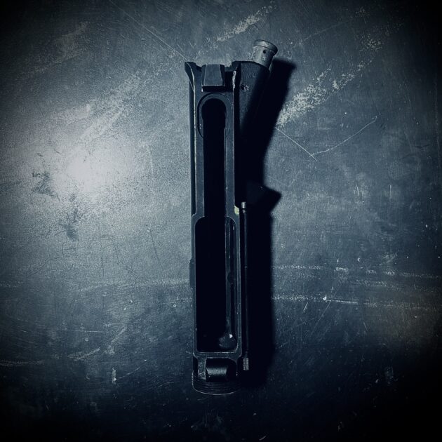 Spots of tan paint showing under black